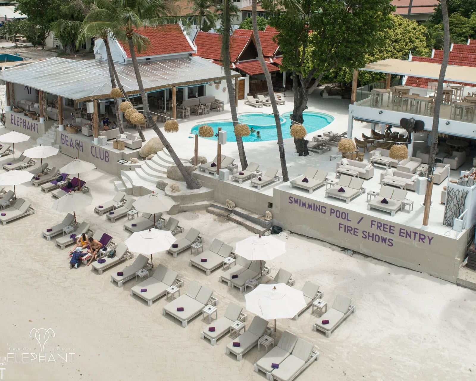 Aerial drone view of the pool, sunbeds and BEACH CLUB signage at Elephant, Chaweng Beach, Koh Samui