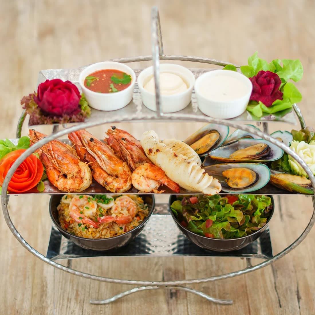 Two-tier seafood platter with grilled tiger prawns, squid and green-lipped mussels, seafood fried rice, salad and three dipping sauces at Elephant