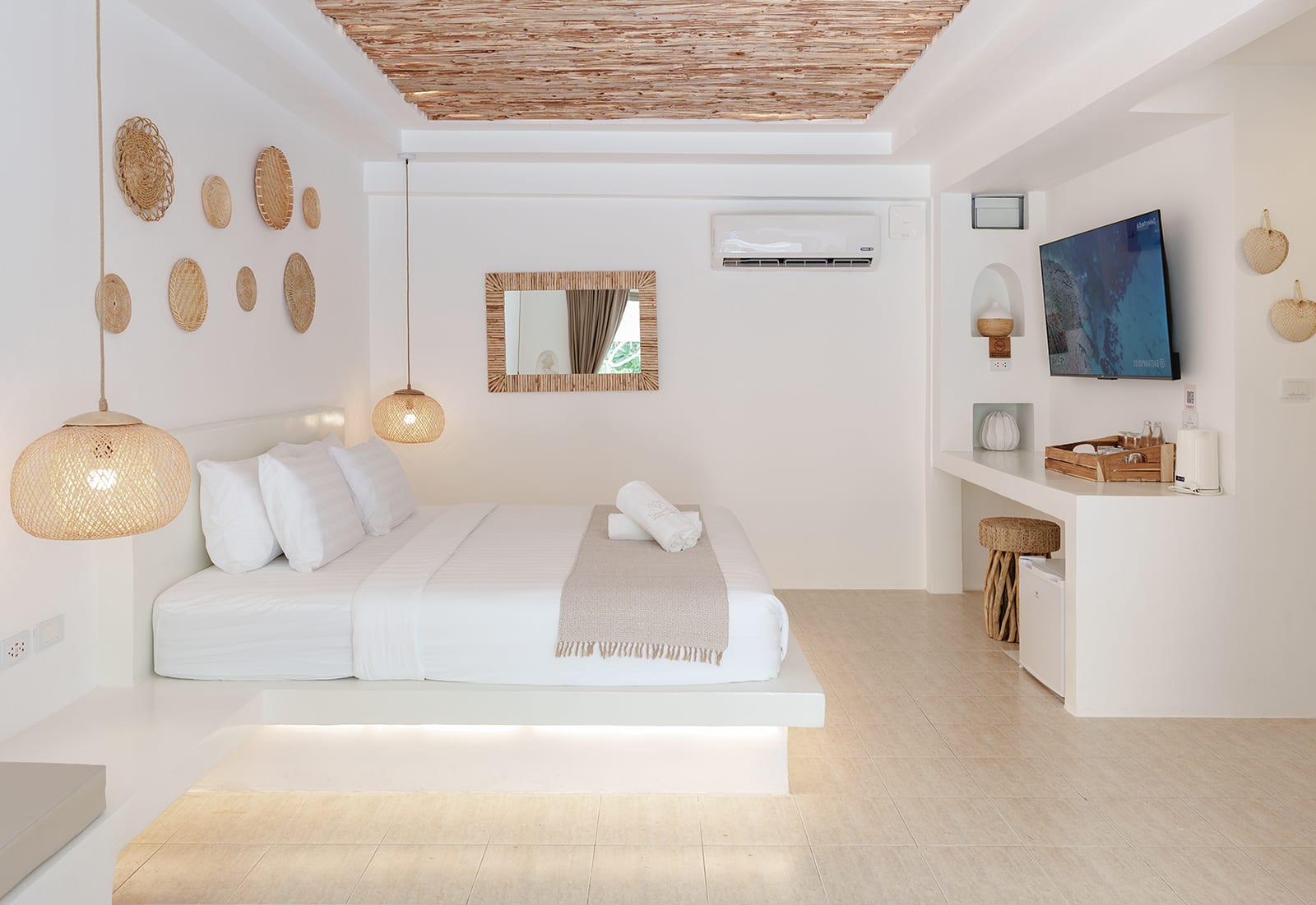 Boho-white boutique room interior with rattan pendant lights and woven wall baskets at Elephant Beach Resort, Koh Samui