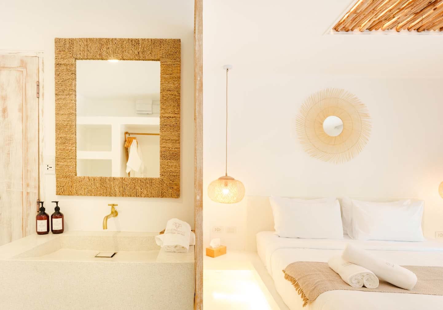 Bathroom mirror and bedroom sunburst mirror side by side in the Deluxe Bungalow, Elephant Beach Resort