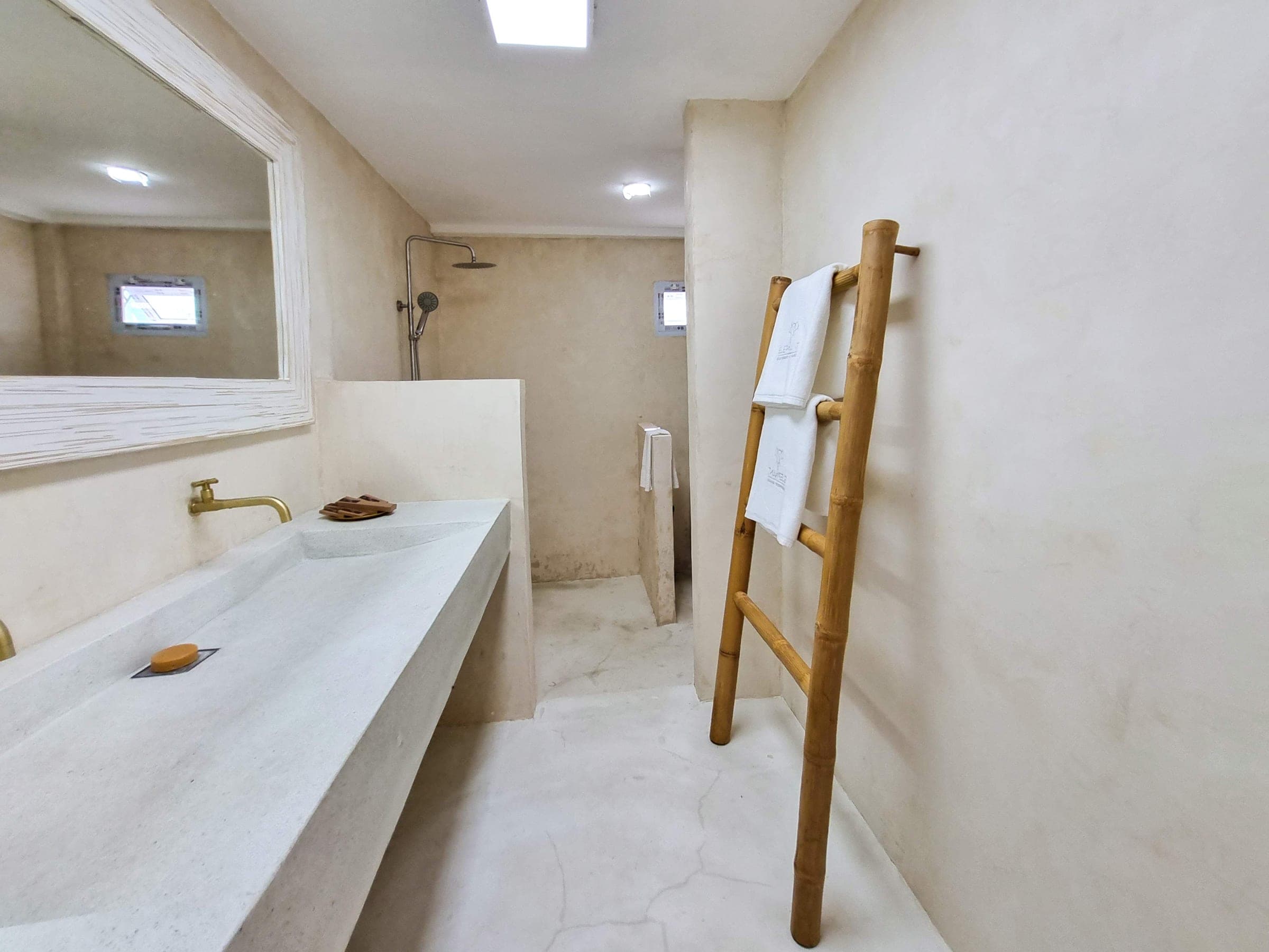 Concrete basin and rain shower in the Luxe Bungalow bathroom at Elephant Beach Resort