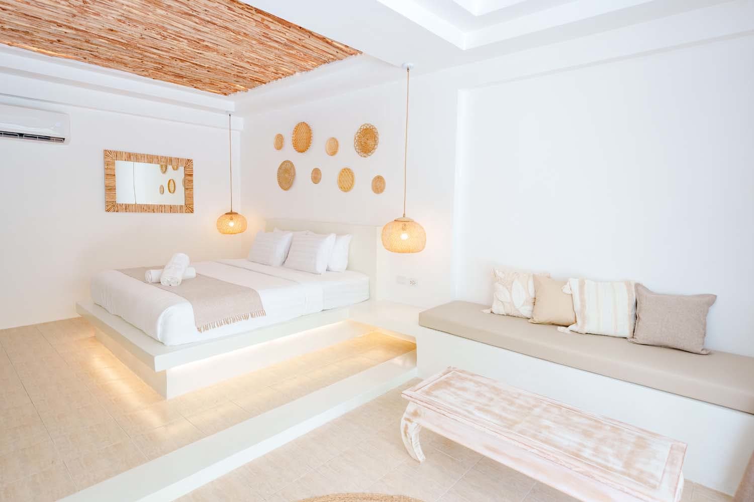 Wardrobe with a robe on a hanger and a woven tote bag in the Luxe Bungalow, Elephant Beach Resort