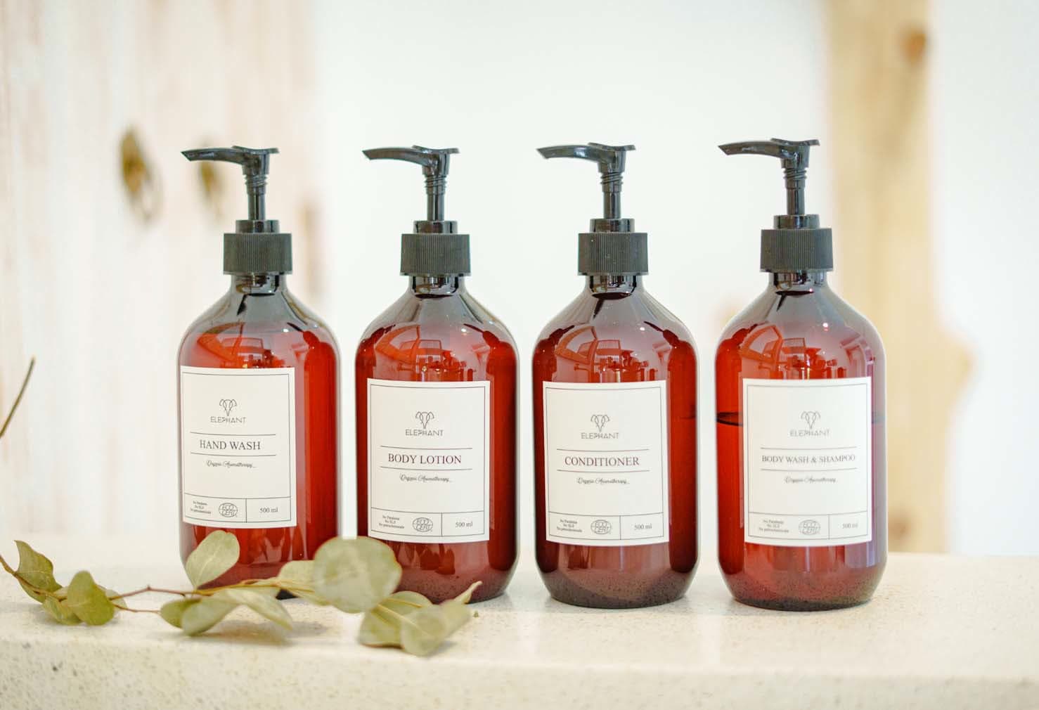 Row of Elephant-branded amenity bottles, hand wash to body wash, in the Luxe Bungalow