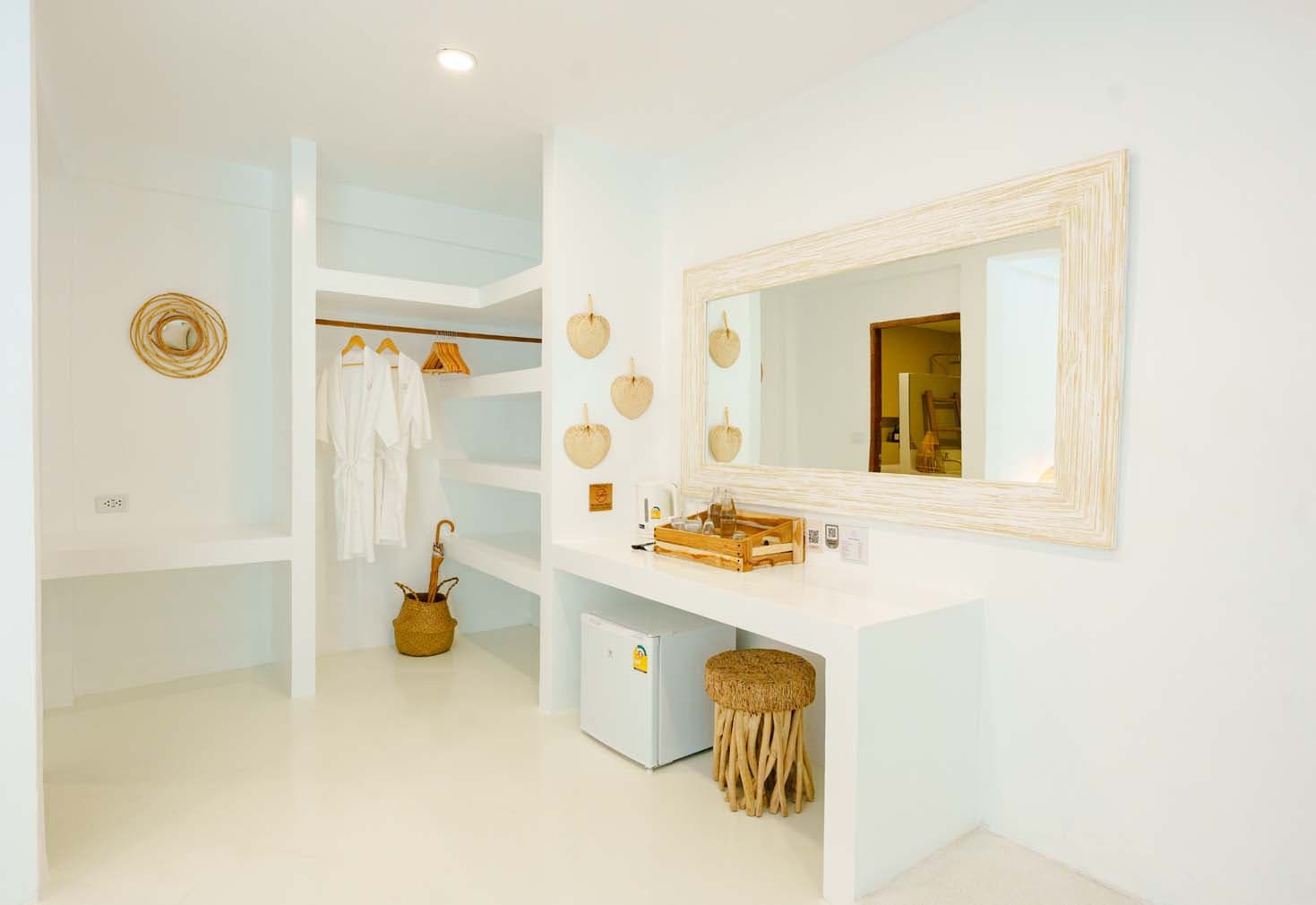 Open wardrobe with bathrobes, vanity desk and framed mirror in the Villa at Elephant Beach Resort, Chaweng Beach