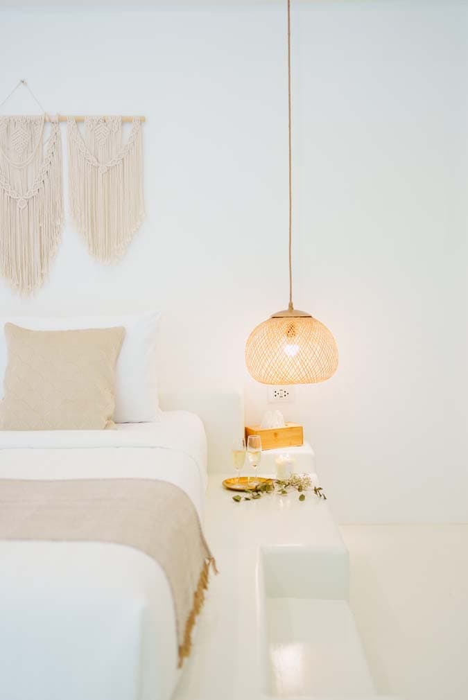 Macrame wall hangings and rattan pendant light beside the Villa bed at Elephant Beach Resort, Koh Samui