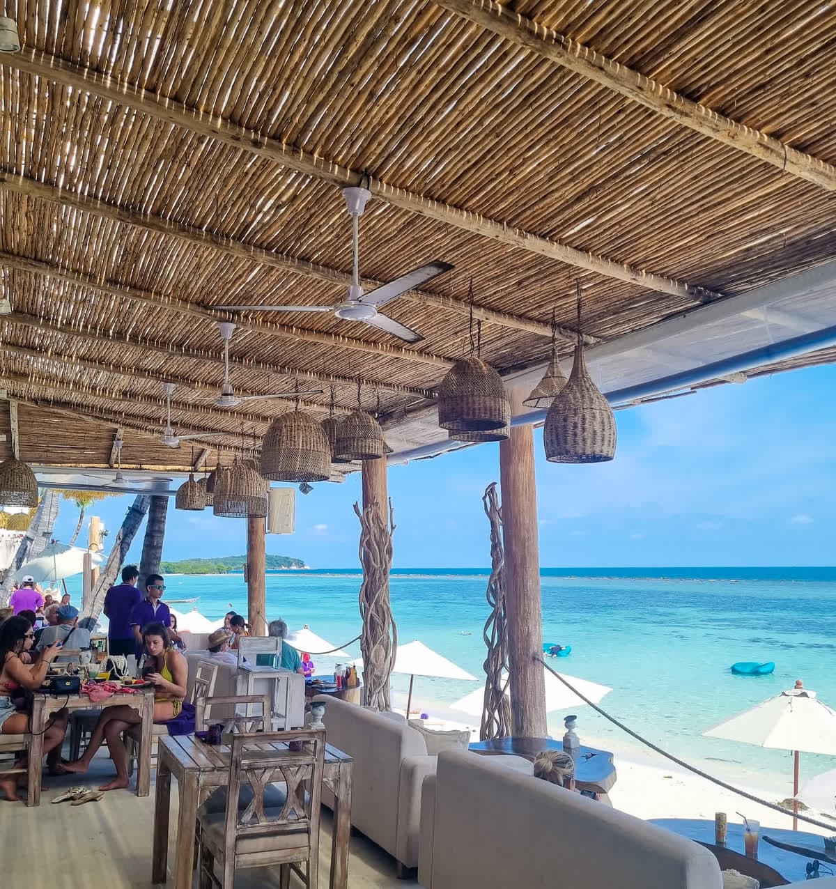 Thatched-roof beachfront terrace overlooking the turquoise water of Chaweng Beach, Elephant Beach Resort