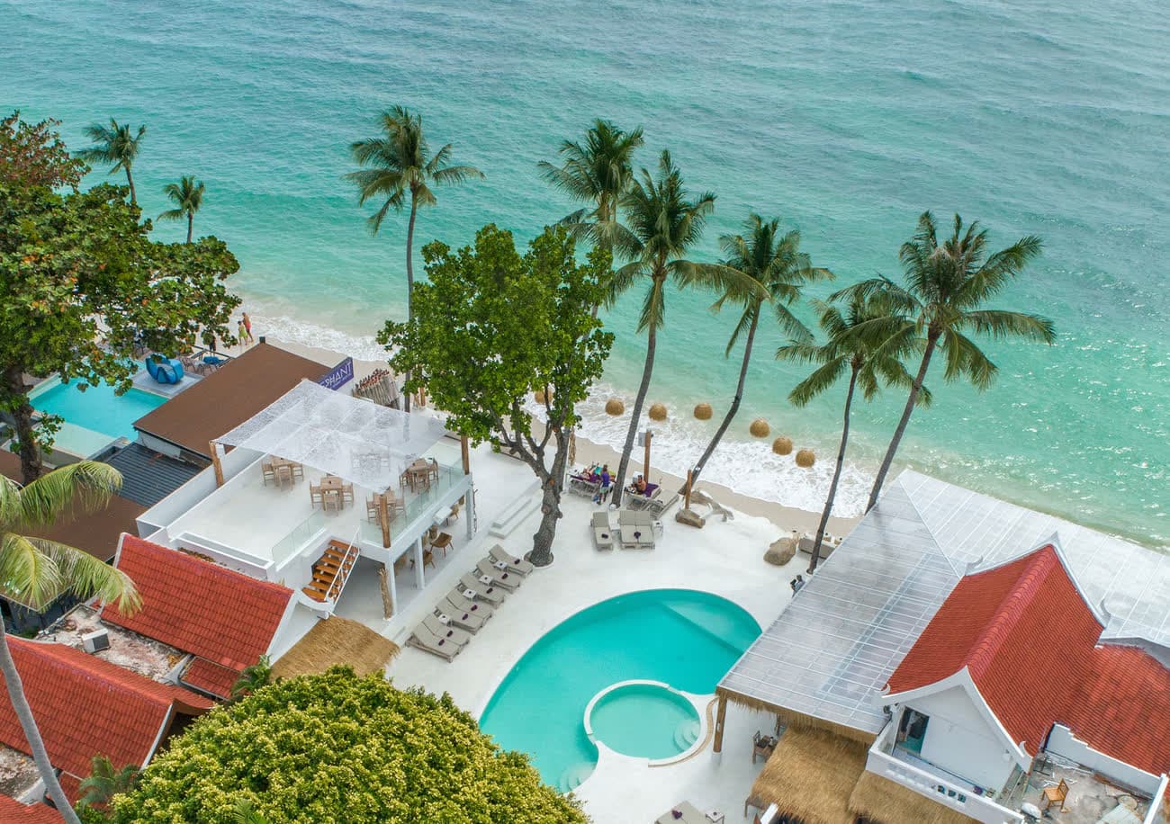 Aerial view of Elephant's swimming pool, sunbeds and beachfront on Chaweng Beach, Koh Samui