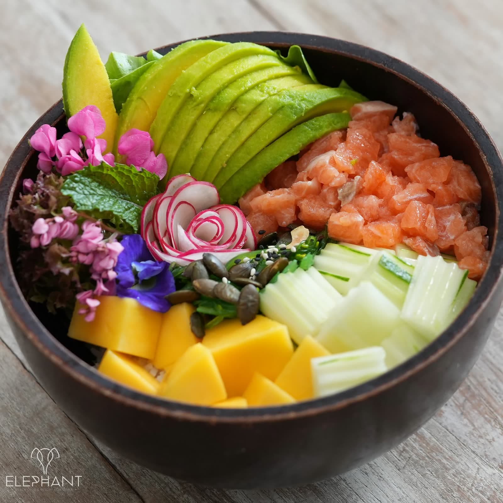 Poke bowl with salmon, avocado, mango and edible flowers at Elephant, Koh Samui